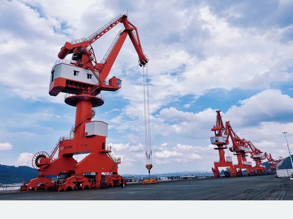 Portal slewing crane handling bulk cargo at a terminal