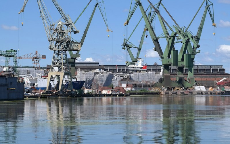 Shipyard cranes lining a harbour yard
