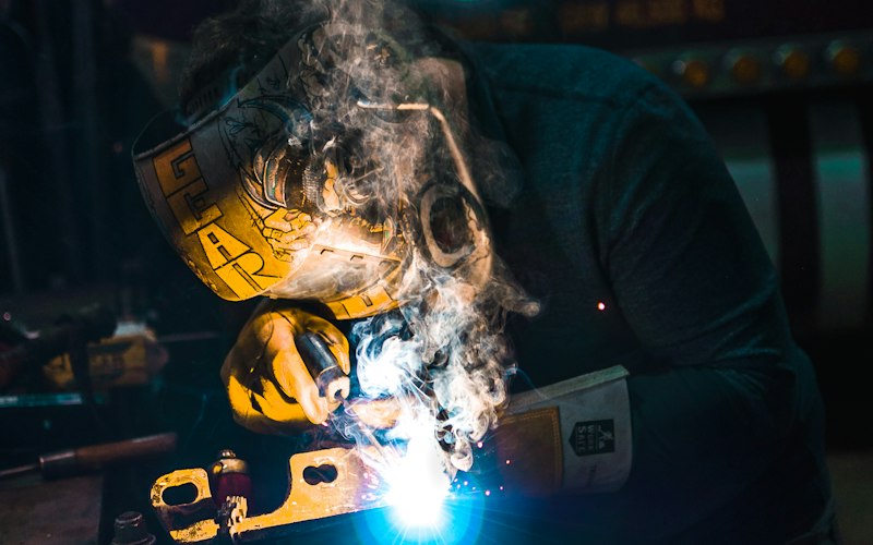 Welder fabricating steel structures in the workshop