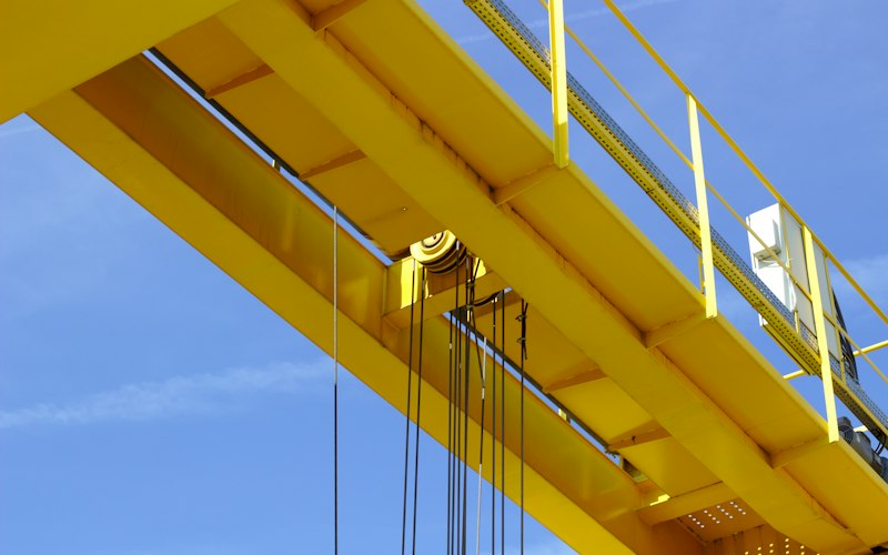 Yellow gantry crane structure on an industrial site